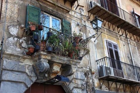 City of Palermo, balcony with flower pots, house facade in the old town, Sicily, Italy