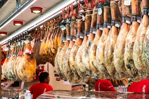 Ham at a market stall at La Boqueria market in Barcelona, Spain