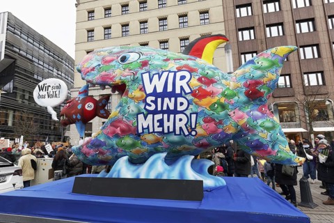 Demonstration against right-wing extremism with motto car We are more, Big fish eats small fish,