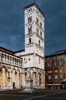 Dark rain clouds over the bell tower of the church of San Michele in Foro, historic city centre,
