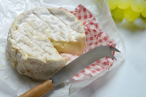 French Camembert with cheese knife, sliced cheese
