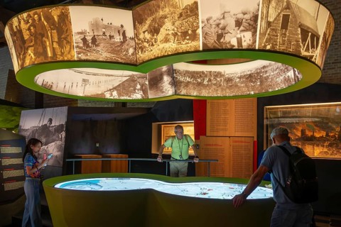 Visitors looking at map in the In Flanders Fields Museum about World War One at Ypres, Ieper, West