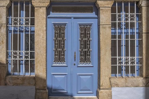 House facade with blue windows and blue front door, Symi Island, Dodecanese, Greece