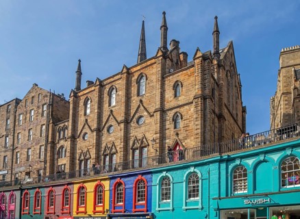 Victoria Street with colourful shops and St. Columba's Free Church of Scotland in the historic Old