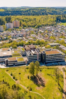Hospital with green roof between forest and urban area, seen from the air, Nagold Hospital of the