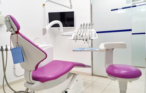A modern dental clinic featuring a clean and organized setting with a purple dental chair, dental