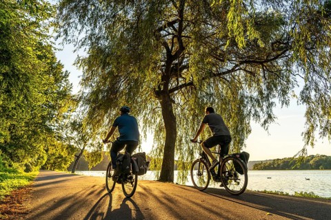 Cycling on Lake Baldeney, around 14 kilometres around the Ruhr reservoir, summer evening on the
