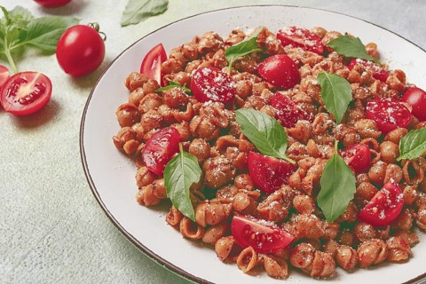 Tuscan pasta with smoked paprika and basil, parmesan cheese, Italian traditional cuisine