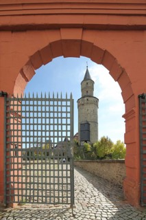 View through archway with metal mesh to historic Hexenturm, landmark, gate, residential castle,
