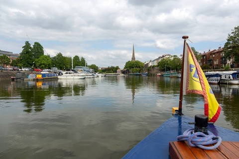 Spire of Saint Mary Redcliff church from Floating Harbour, Bristol, England, UK view from ferry
