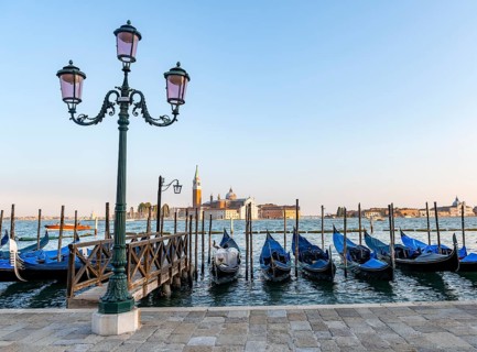 View of Venetian gondolas, boat dock at St. Mark's Square, San Giorgio Maggiore church in the