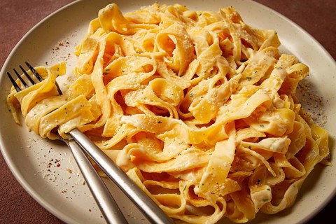 Fettuccine, tagliatelle, in creamy garlic sauce, Italian traditional cuisine, pasta carbonaro