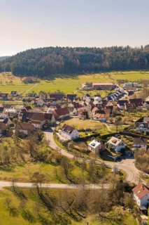 Hilly village with residential buildings and roads in a sunny, green landscape, Pfrondorf, Nagold,
