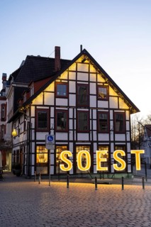 Letters form the word Soest in front of a half-timbered house, Blue Hour, Soest, North