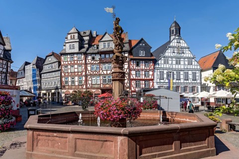 Kump, medieval market fountain, fountain figure market fountain man with market flag, sandstone
