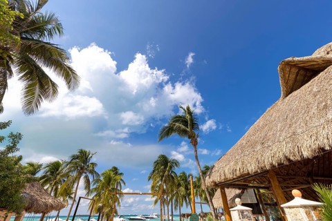 Serene turquoise Isla Mujeres beach Playa Norte famous for emerald waters, sandy sea shore and