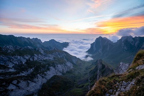 View over Säntis mountains into the valley of Meglisalp at sunrise, high fog in the valley, Säntis,