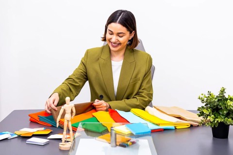 A professional image consultant at work, displaying vibrant fabric swatches and design tools. The