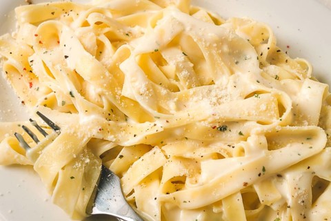 Fettuccine, tagliatelle, in creamy garlic sauce, Italian traditional cuisine, pasta carbonaro
