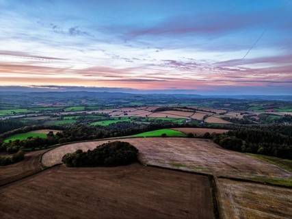 Sunset of Devon Farms and Fields over Berry Pomeroy from a drone, Totnes, England, United Kingdom