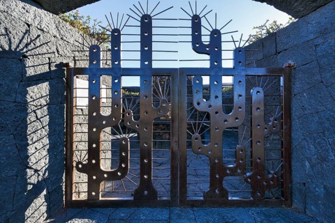 Wrought-iron entrance gate, stylised cacti, cactus garden, succulent garden Jardín de Cactus,