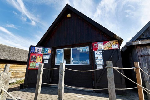 Kiosk sells traditional smoked fish in the harbour, fishing village Djupvik, also Djauvik, fishing