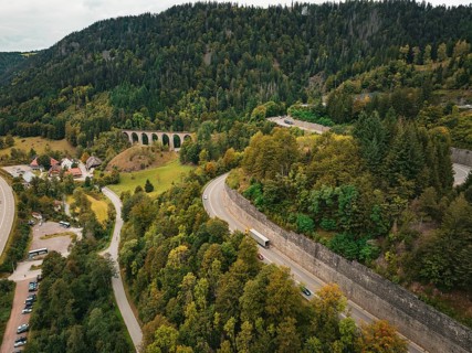 Road and viaduct in the middle of forest and village, Ravenna Gorge, Black Forest, Germany