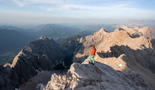 Mountaineer on a steep rocky ridge, impressive mountain landscape, view of the Höllental and the