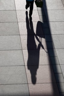 Passers-by with shade, shopping bag and umbrella, winter, Saxony, Germany