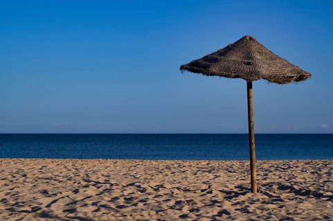 Bast parasol, sea, sandy beach, Meia Praia beach, Lagos, Atlantic Ocean, evening light, Algarve,