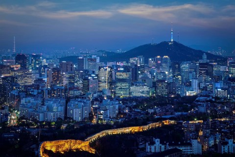 Seoul downtown cityscape illuminated with lights and Namsan Seoul Tower in the evening view from