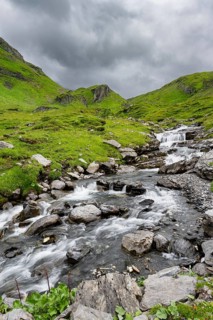 Bergbach Sousbach flows through picturesque green mountain landscape, long exposure, Bernese Alps,