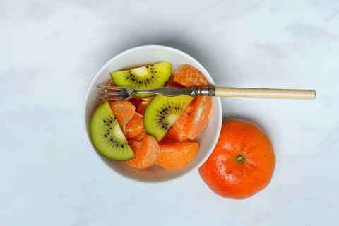 Clementine pieces and kiwi slices in peel