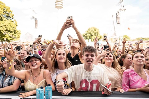 Festival-goers celebrate during Ikkimel's performance at the Superbloom Festival in Munich's