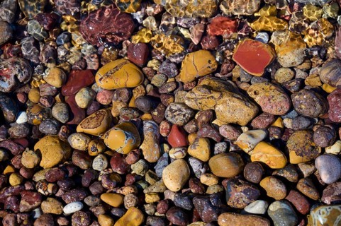 Varied colourful pebbles under water, whose colours and textures blend into nature, Lambi beach,