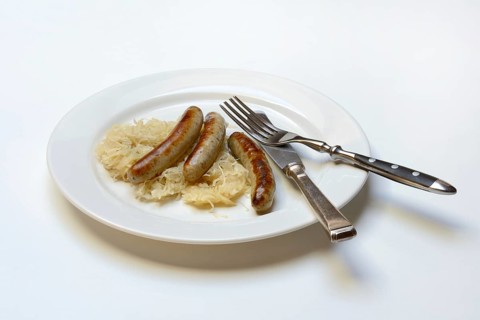 Nuremberg sausages with sauerkraut on a plate, Rostbratwurst, Germany