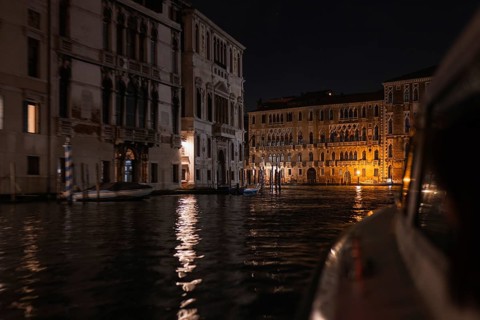 The enchanting beauty of Venetian architecture as the illuminated facades reflect on the serene