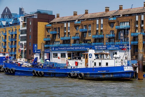 A Thames Marine Services fuel and lubricant tanker moored at its riverside base at Wapping, London,