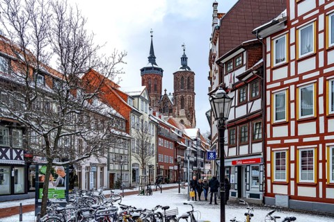 Half-timbered houses and St John's Church in Göttingen in winter, Lower Saxony, Germany