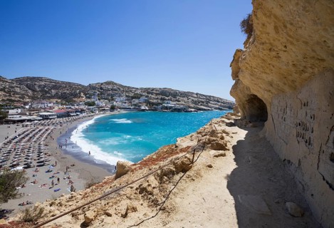 View from the rock caves to the beach of Matala, south coast, Crete, Greece