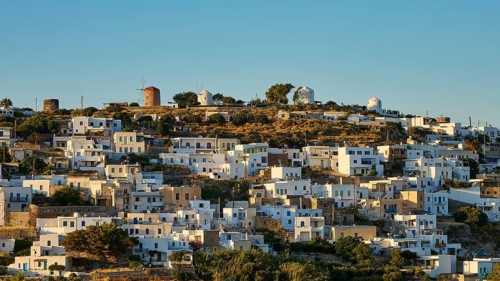 Whitewashed houses and windmills on a hill under clear sky, Trypiti, Tripiti, village, Milos,