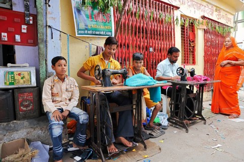 Man and children working on sewing machines on the roadside, Bharatpur, Rajasthan, India