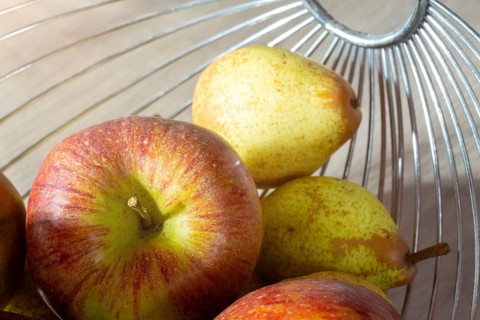 Close-up of apples and pears in the fruit basket