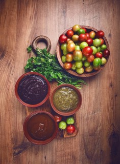 Set of tkemali sauces, three types of tkemali sauce, in ceramic bowls, top view, Georgian cuisine,
