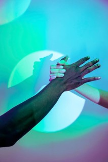 A vibrant image showcasing multiethnic hands clasped together, symbolizing unity and diversity. The