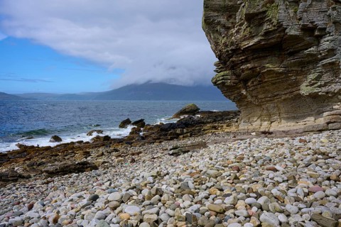 Large rocks on rocky beach with sea view and slightly cloudy sky, Elgol Beach, Elgol, Isle of Skye,