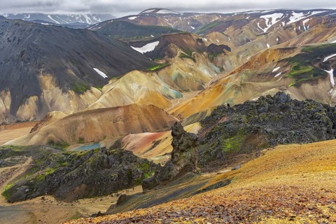 Small river between colourful rhyolite mountains, volcanic landscape, erosion landscape, view from