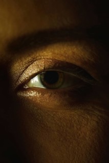 A close up image capturing a woman eye, showcasing the intricate details of the eyelashes, skin