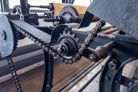 Bramsche, Lower Saxony, Germany, Close-up of metal chains and gears of an industrial machine