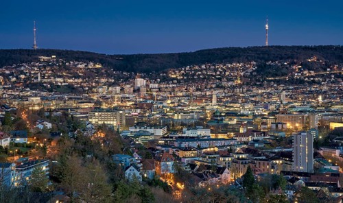 Panoramic night view of Stuttgart city center in Germany with glowing city lights, dense urban